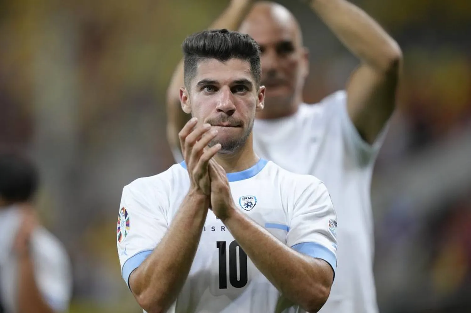 Israel's Manor Solomon applauds supporters at the end of the Euro 2024 qualifying soccer match between Romania and Israel at the National Arena stadium in Bucharest, Romania, Saturday, Sept. 9, 2023. (AP) 