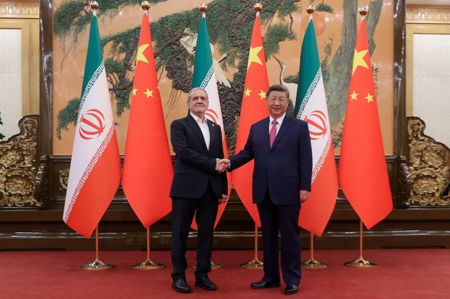 02 September 2025, China, Peking: Iran's President Masoud Pezeshkian shakes hands with China's President Xi Jinping in Beijing. (Iranian Presidency /dpa)