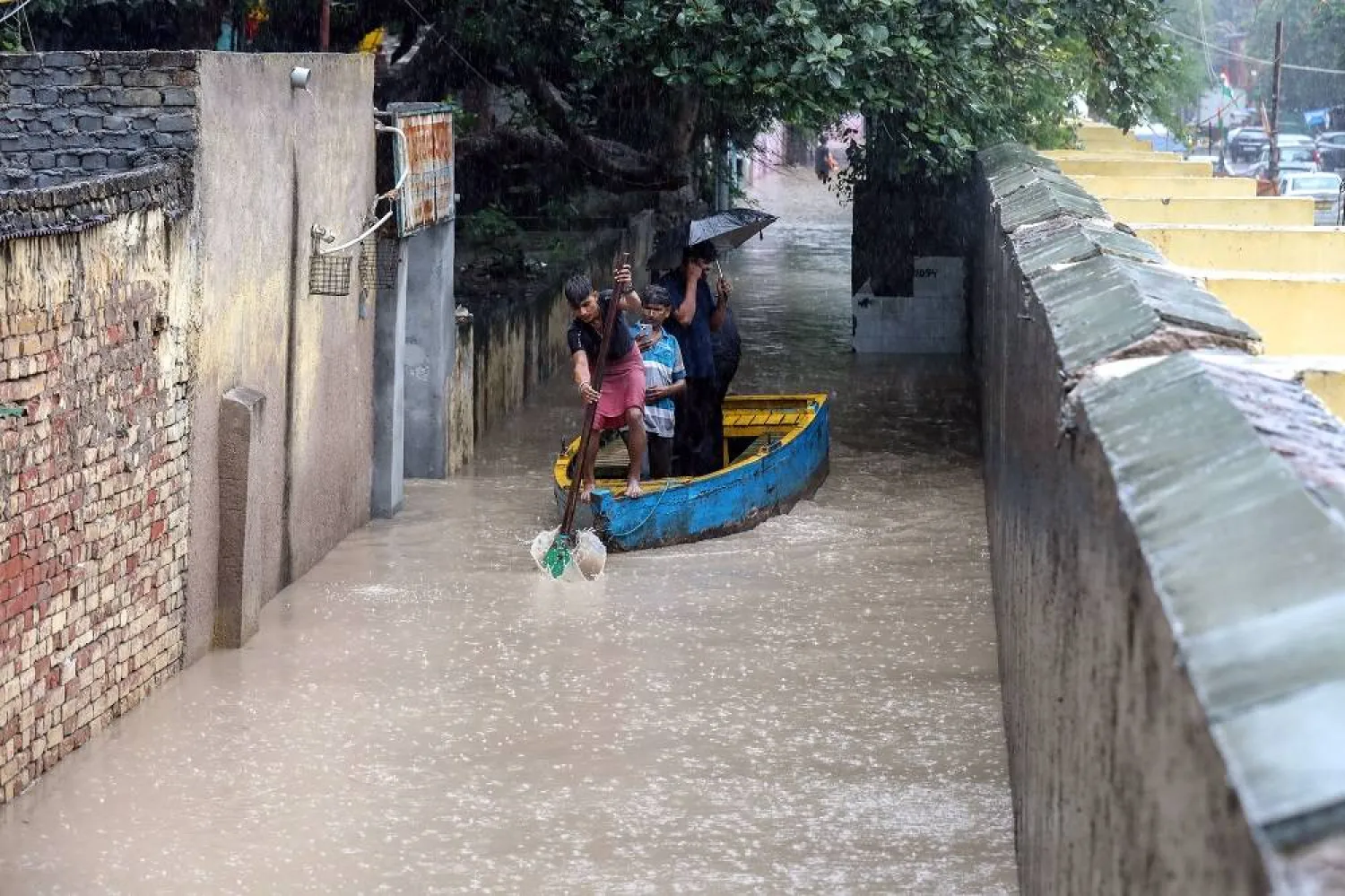 Residents use a boat to cross the flood waters from the swollen Yamuna River at Yamuna Bazar in New Delhi, India, 02 September 2025. (EPA)