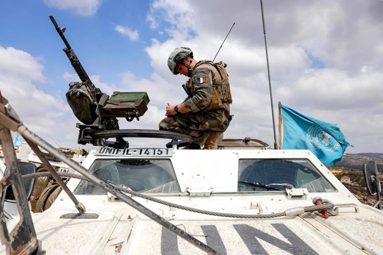 A French peacekeeper of the United Nations Interim Force in Lebanon (UNIFIL) sits atop a stopped armored vehicle during a patrol in the village of Kfar Kila in southern Lebanon near the border with northern Israel on August 27, 2025. (Photo by ANWAR AMRO / AFP)