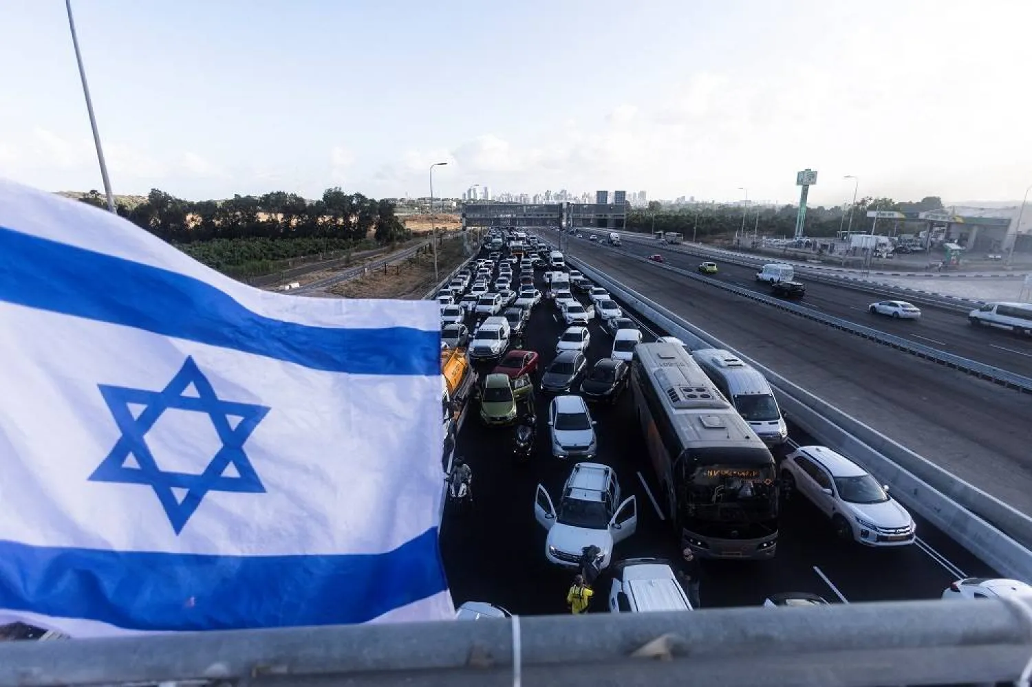 Vehicles line up as protesters block a main road during a demonstration demanding the immediate end of the war and the release of all hostages who were kidnapped during the deadly October 7, 2023, attack on Israel by Hamas, in Yakum near Tel Aviv, Israel, August 26, 2025. (Reuters)