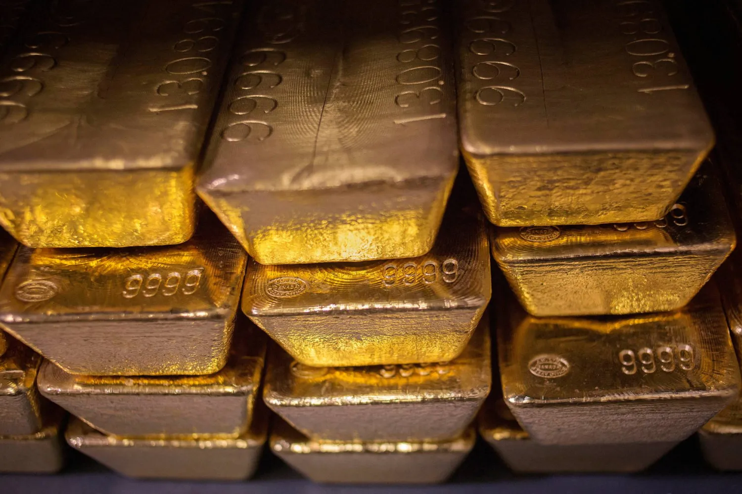 FILE PHOTO: Twenty four karat gold bars are seen at the United States West Point Mint facility in West Point, New York June 5, 2013. REUTERS/Shannon Stapleton/File Photo