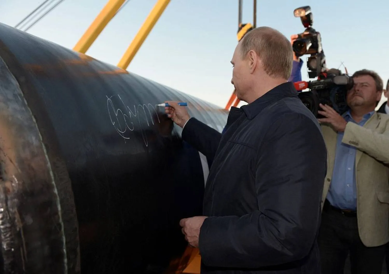 Russia's President Vladimir Putin signs on the first segment of pipeline during a ceremony marking the start of construction of "Power of Siberia" pipeline at the village of Us Khatyn, September 1, 2014. (Reuters file) 
