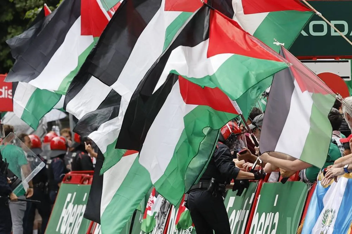 Ertzaintza police force members secure the perimeter as members of the Gernika Palestine initiative a protest against the participation of the Israel Premier Tech team and in support of Palestinians, during the 11th stage of the La Vuelta a Espana cycling race over 157.4km from Bilbao to Bilbao, Spain, 03 September 2025. (EPA)