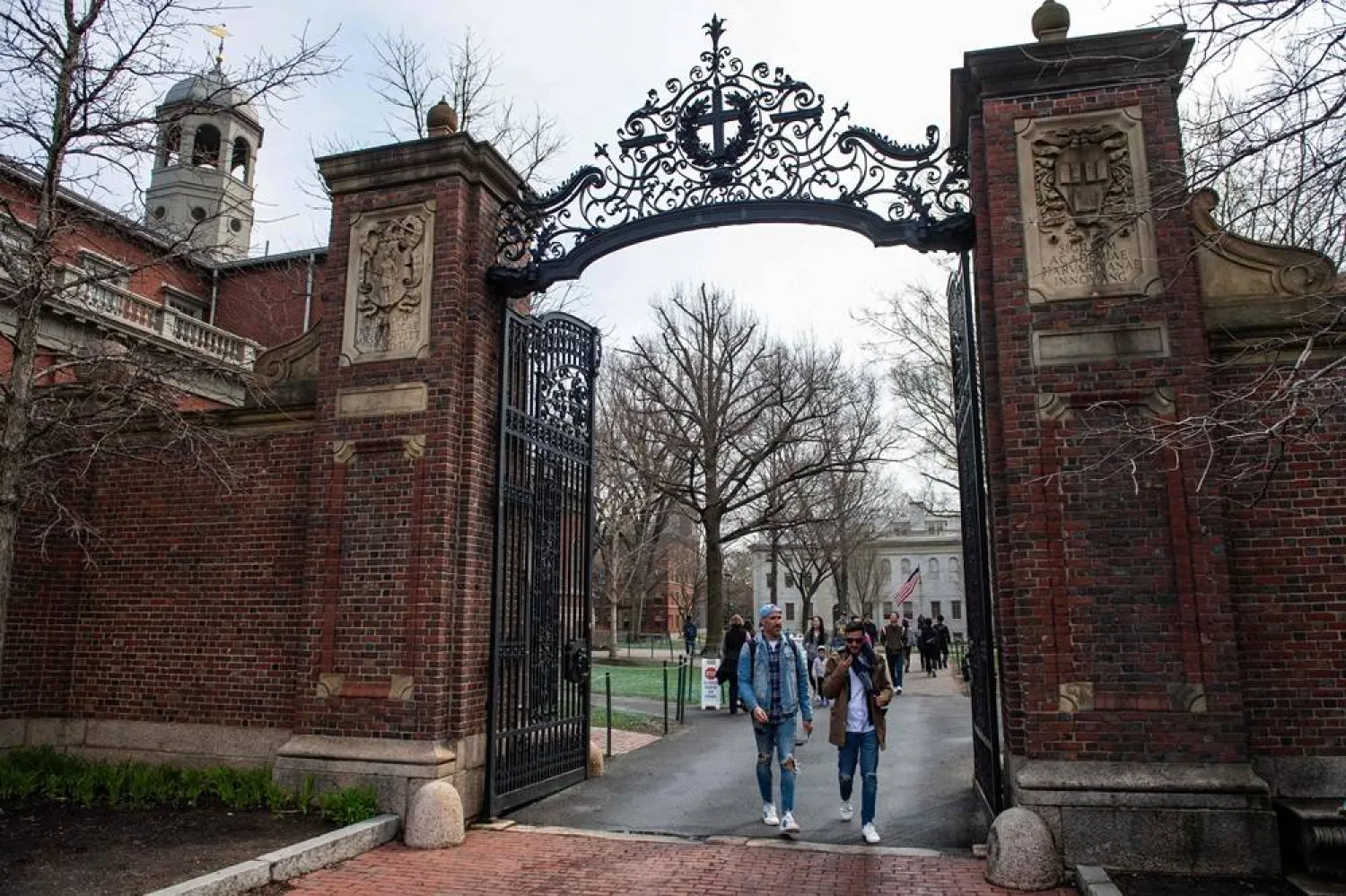 People walk through a gate as they exit Harvard Yard on the campus of Harvard University campus in Cambridge, Massachusetts, on April 15, 2025. (AFP)