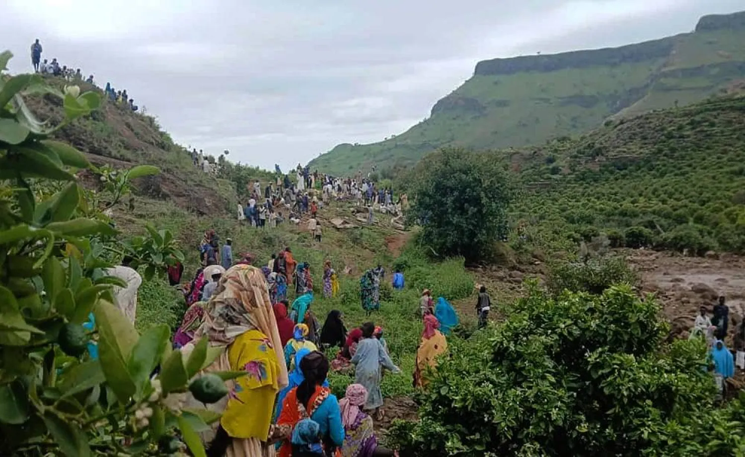 In this Monday, Sept. 1, 2025, photo provided by the Sudan Liberation Movement/Army, people gather at the site of a landslide from Aug. 1, that wiped out the village of Tarasin in the Marrah Mountains of Central Darfur, Sudan. (Sudan Liberation Movement/Army via AP) 