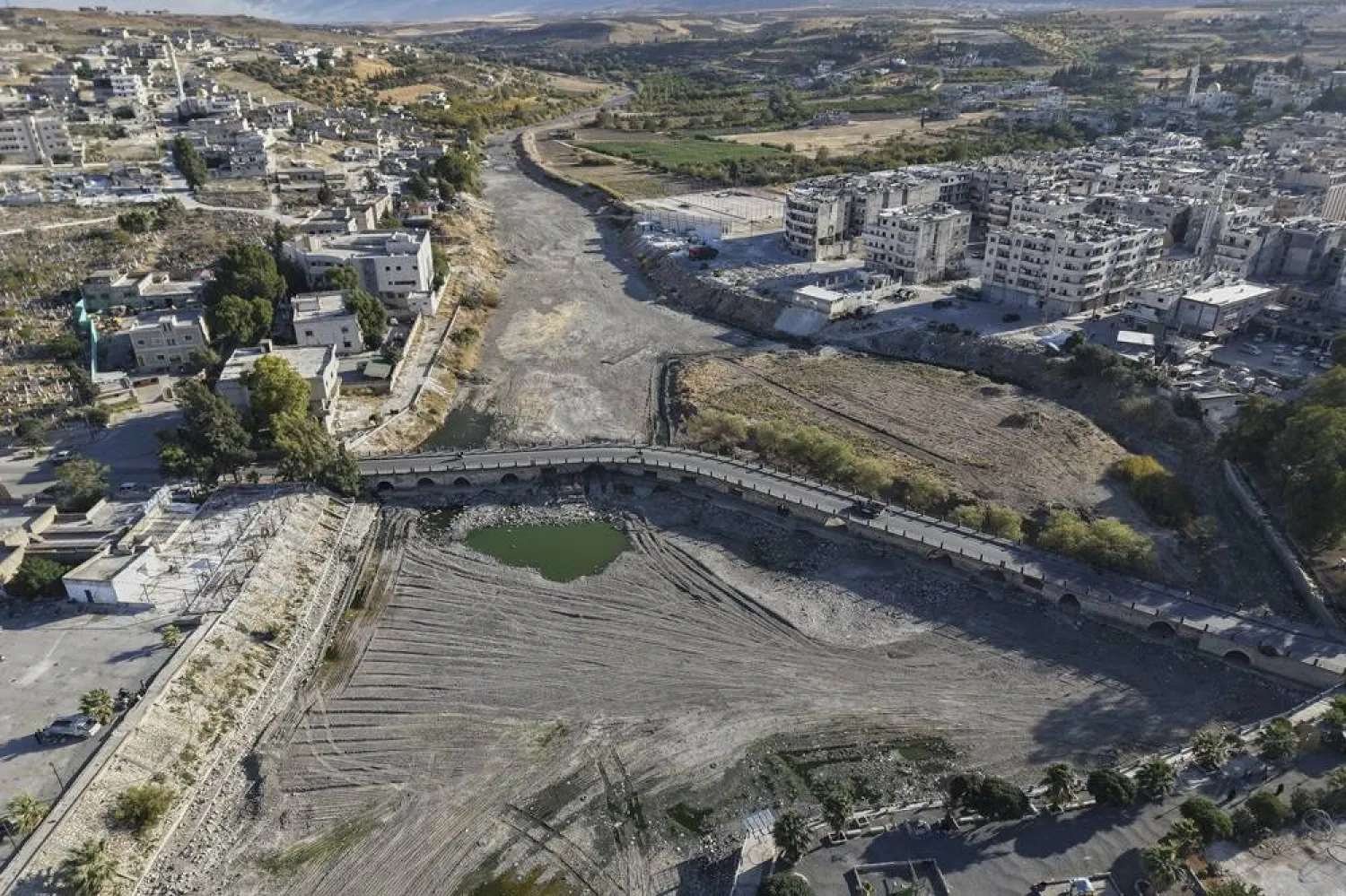 A drone view shows the dried up Orontes River in Jisr al-Shughour, west of Idlib, Syria, on Aug. 14, 2025. (AP) 