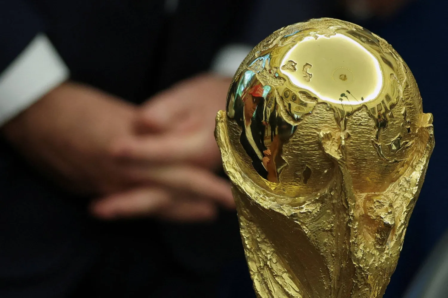 US President Donald Trump and Vice President JD Vance are reflected in the FIFA World Cup Trophy, as President Trump makes an announcement on the 2026 FIFA World Cup, in the Oval Office at the White House in Washington, D.C., US, August 22, 2025. REUTERS/Jonathan Ernst