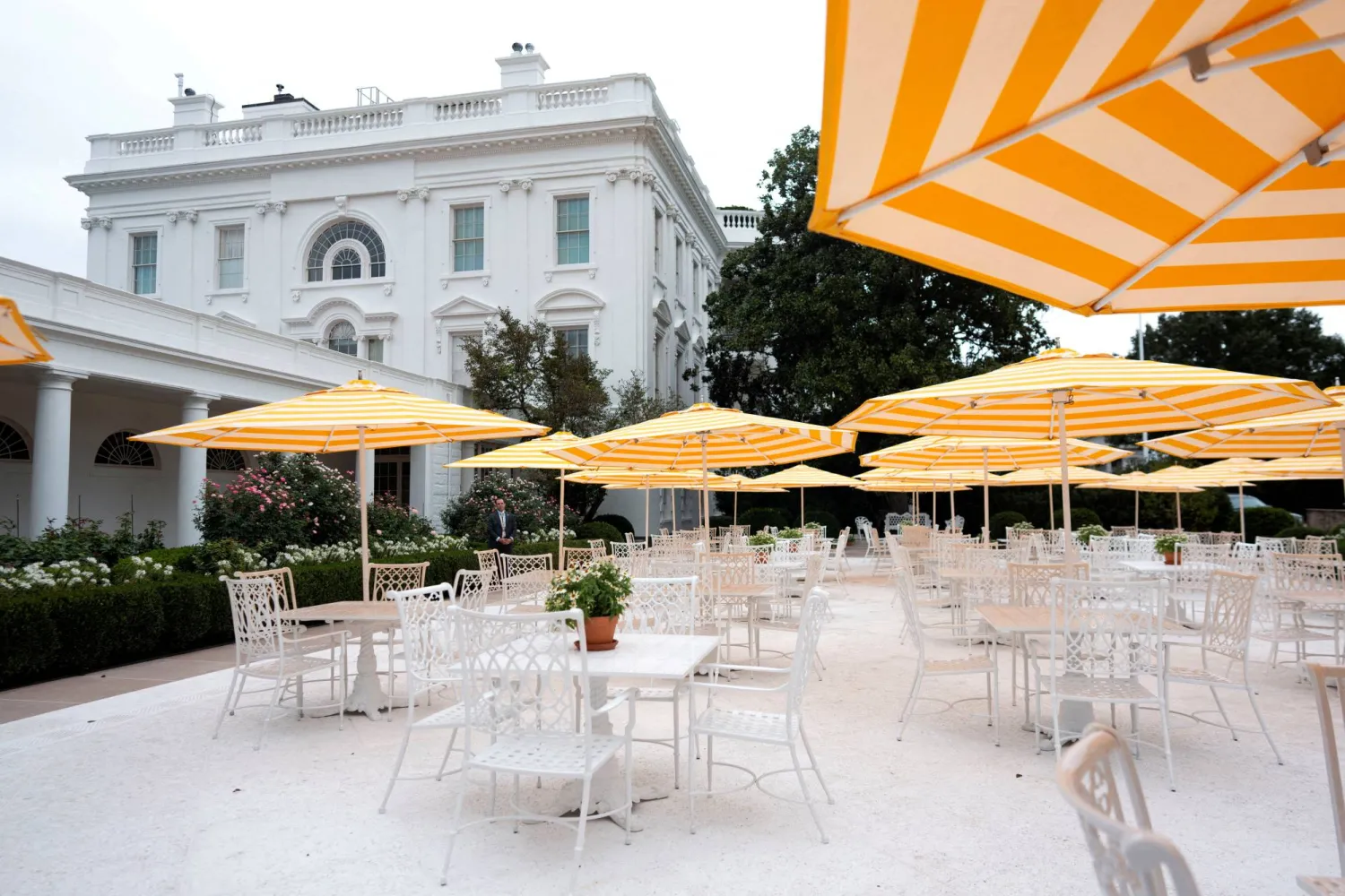 FILE PHOTO: Yellow and white striped umbrellas stand open in the recently renovated Rose Garden at the White House in Washington, D.C., US, August 19, 2025. Doug Mills/Pool via REUTERS/File Photo