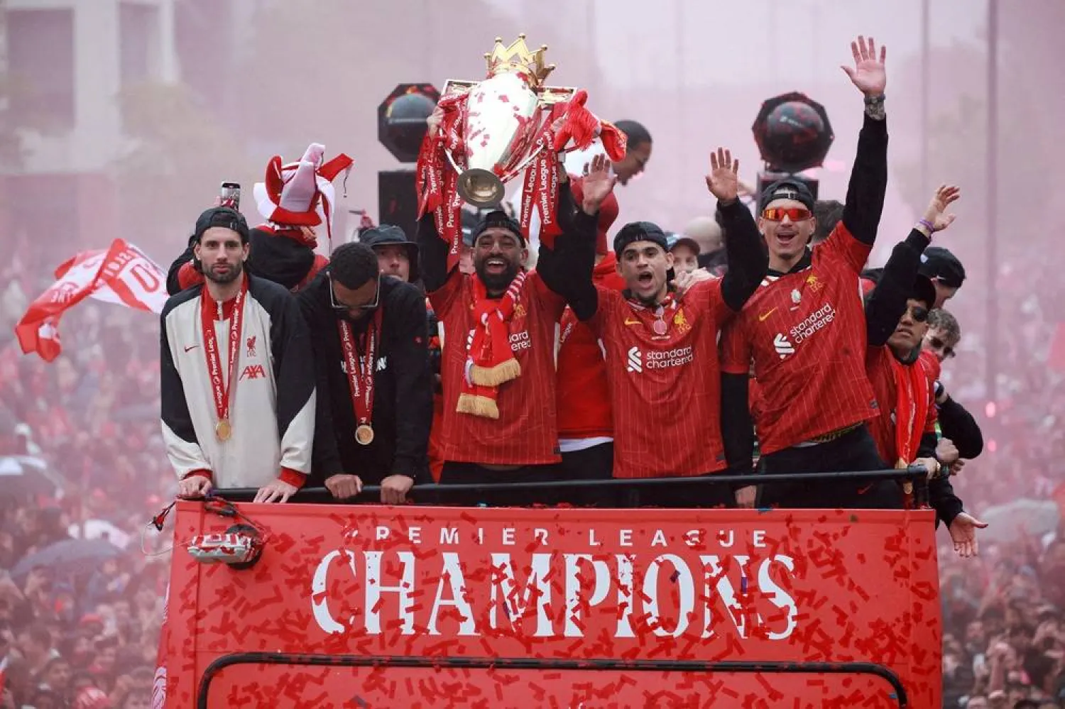 Football - Premier League - Liverpool Victory Parade - Liverpool, Britain - May 26, 2025 Liverpool's Mohamed Salah celebrates with the trophy and Dominik Szoboszlai, Luis Diaz and Darwin Nunez after winning the Premier League on the bus during the Victory parade. (Reuters) 