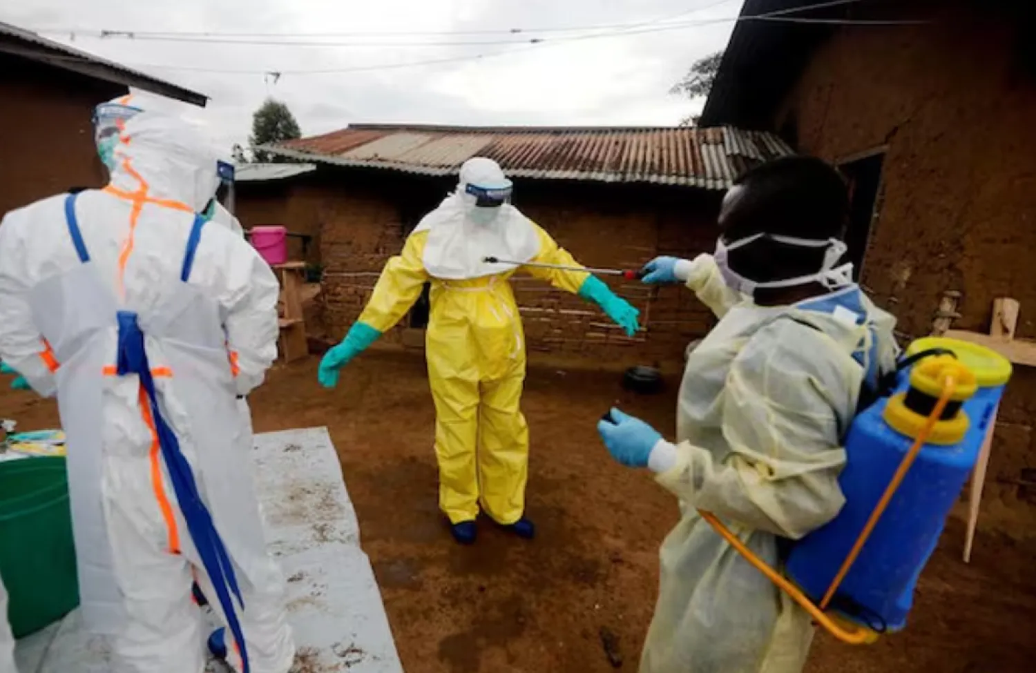 A healthcare worker, who volunteered in the Ebola response, decontaminates his colleague in the eastern Congolese town of Beni in the Democratic Republic of Congo, October 8, 2019. REUTERS/Zohra Bensemra/File Photo 