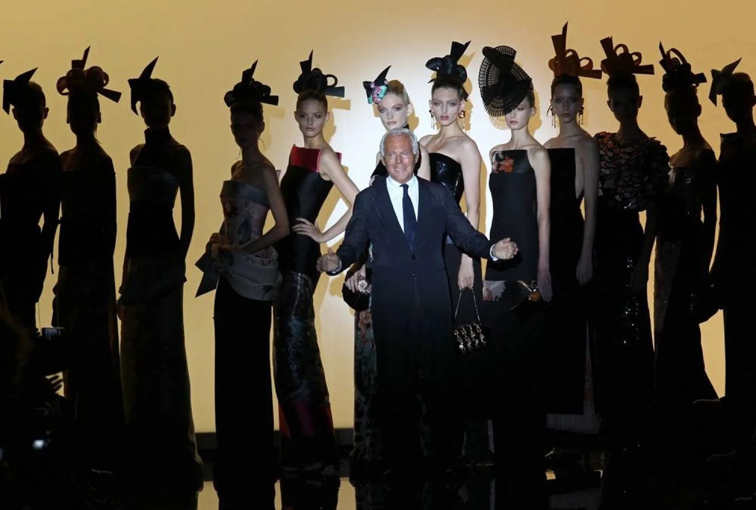 Italian designer Giorgio Armani acknowledges the public at the end of the Giorgio Armani Prive during the Fall/Winter 2011-2012 Haute Couture Collection Show on July 5, 2011 in Paris. (AFP) 