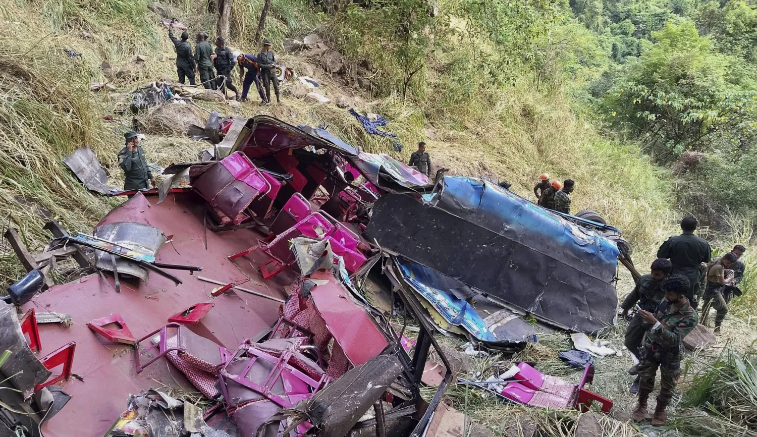 Soldiers and rescue workers stand by the debris of a passenger bus after it plunged into a precipice in Wellawaya, Sri Lanka, Friday, Sept. 5, 2025. (AP Photo/Prasanna Pathmasiri)