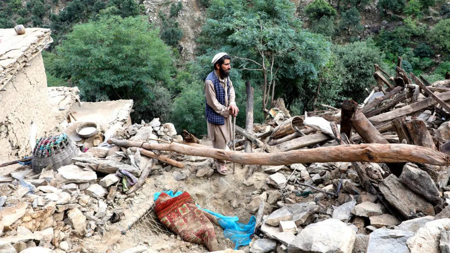 A man stands in the rubble of his quake -shattered home in Nurgal, Eastern Afghanistan, on September 4. AFP
