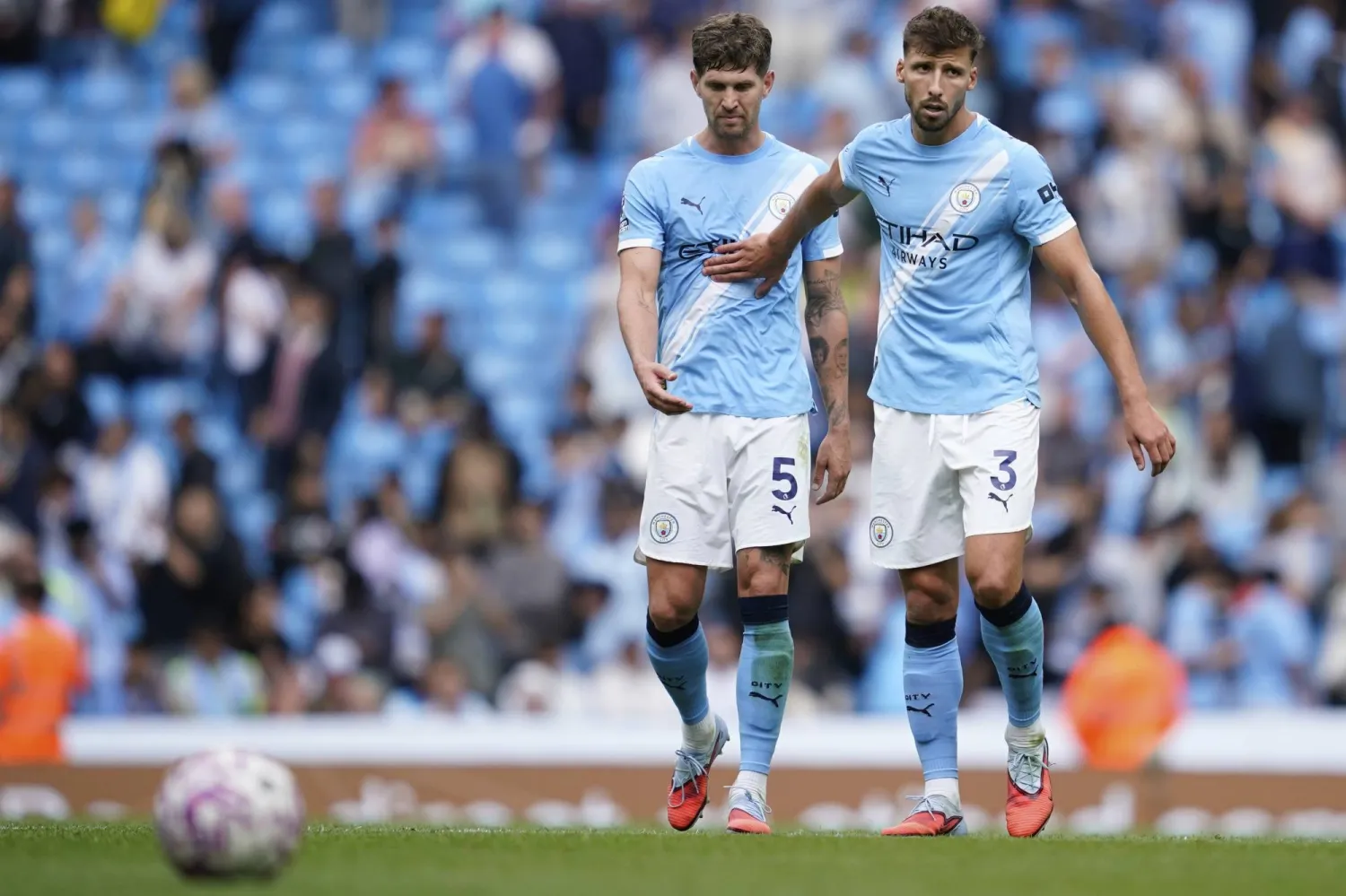 Manchester City's John Stones, left, and Ruben Dias walk off the pitch after the Premier League soccer match between Manchester City and Tottenham in Manchester, England, Saturday, Aug. 23, 2025. (AP Photo/Dave Thompson)