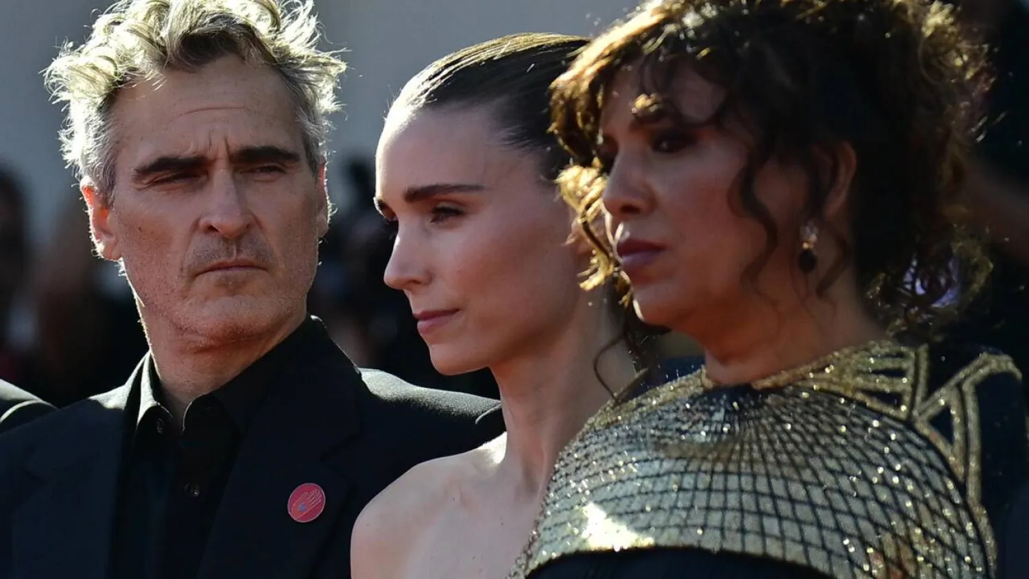 The powerful movie, by French-Tunisian director Kaouther Ben Hania (R), has garnered Hollywood backing from the likes of Joaquin Phoenix (L) and Rooney Mara (C). Tiziana FABI / AFP/File
