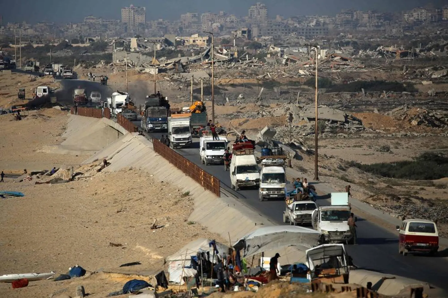 Vehicles transporting Palestinians fleeing south, drive along the coastal road near the Nuseirat camp in the central Gaza Strip, on August 5, 2025. (AFP)