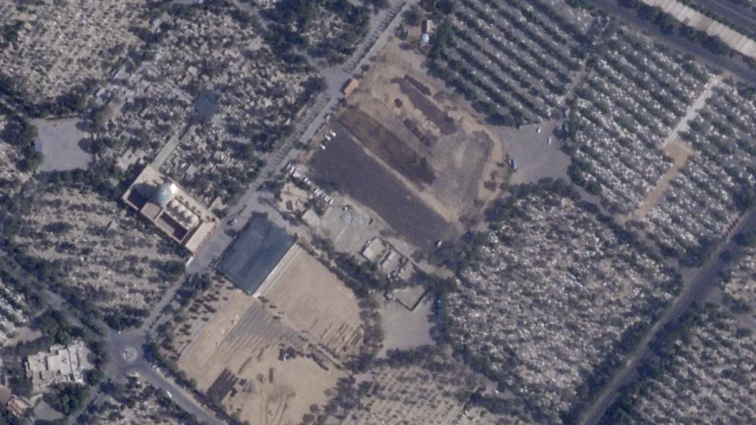 This satellite photo provided by Planet Labs PBC shows Iran paving over Lot 41, where some of those executed in the chaos after Iran’s 1979 Iranian  Revolution were buried, at Behesht-e Zahra cemetery outside of Tehran, Iran, on August 18, 2025. Photo Credit: AP via Planet Labs PBC

