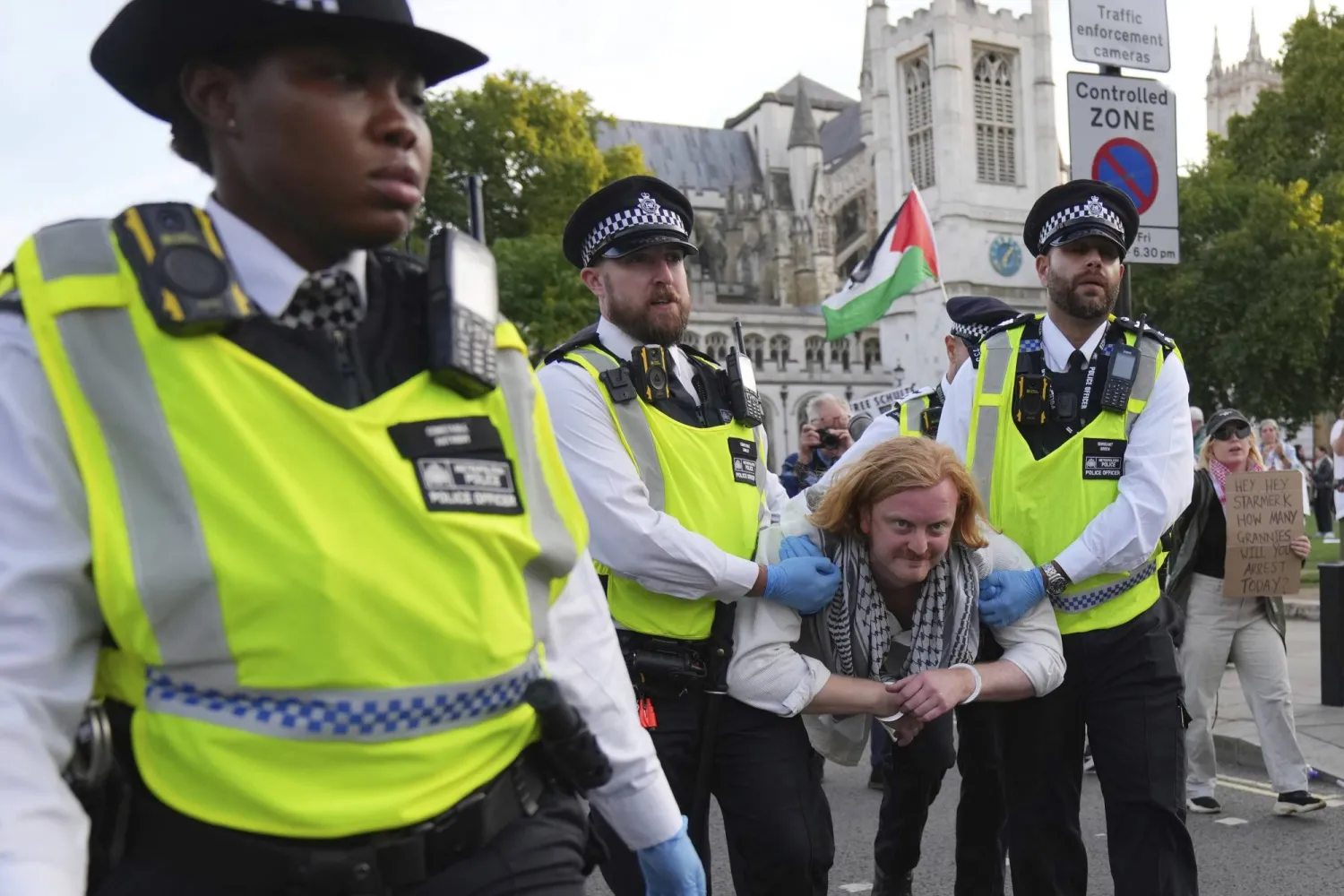 Police officers carry a protester during a protest to support Palestine Action in London, Saturday, Sept. 6, 2025.(AP Photo/Joanna Chan)