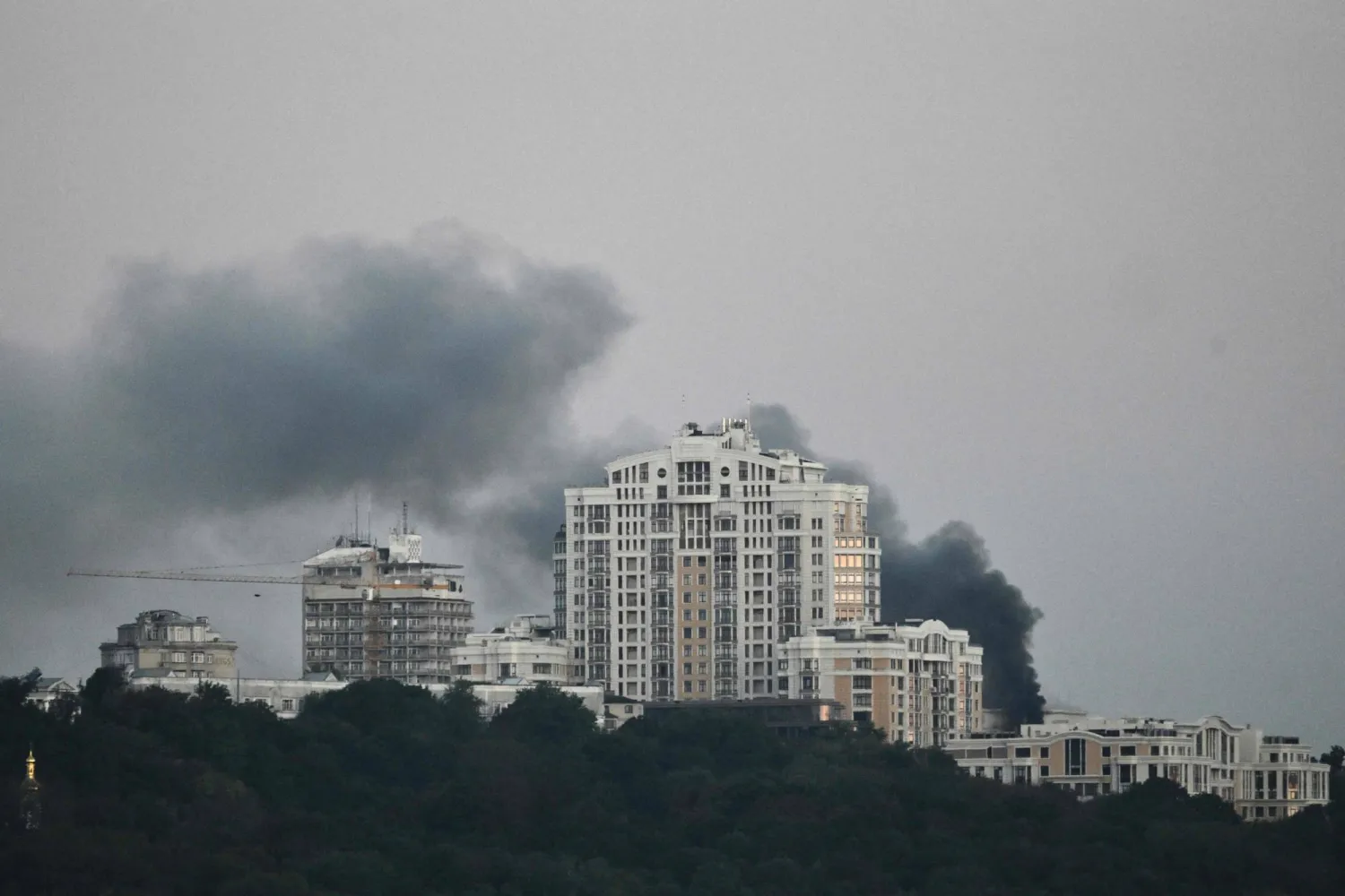 Smoke rises over the government headquarters in Kyiv, following Russian drone and missile strikes on September 7, 2025, amid the Russian invasion of Ukraine. (Photo by Genya SAVILOV / AFP)