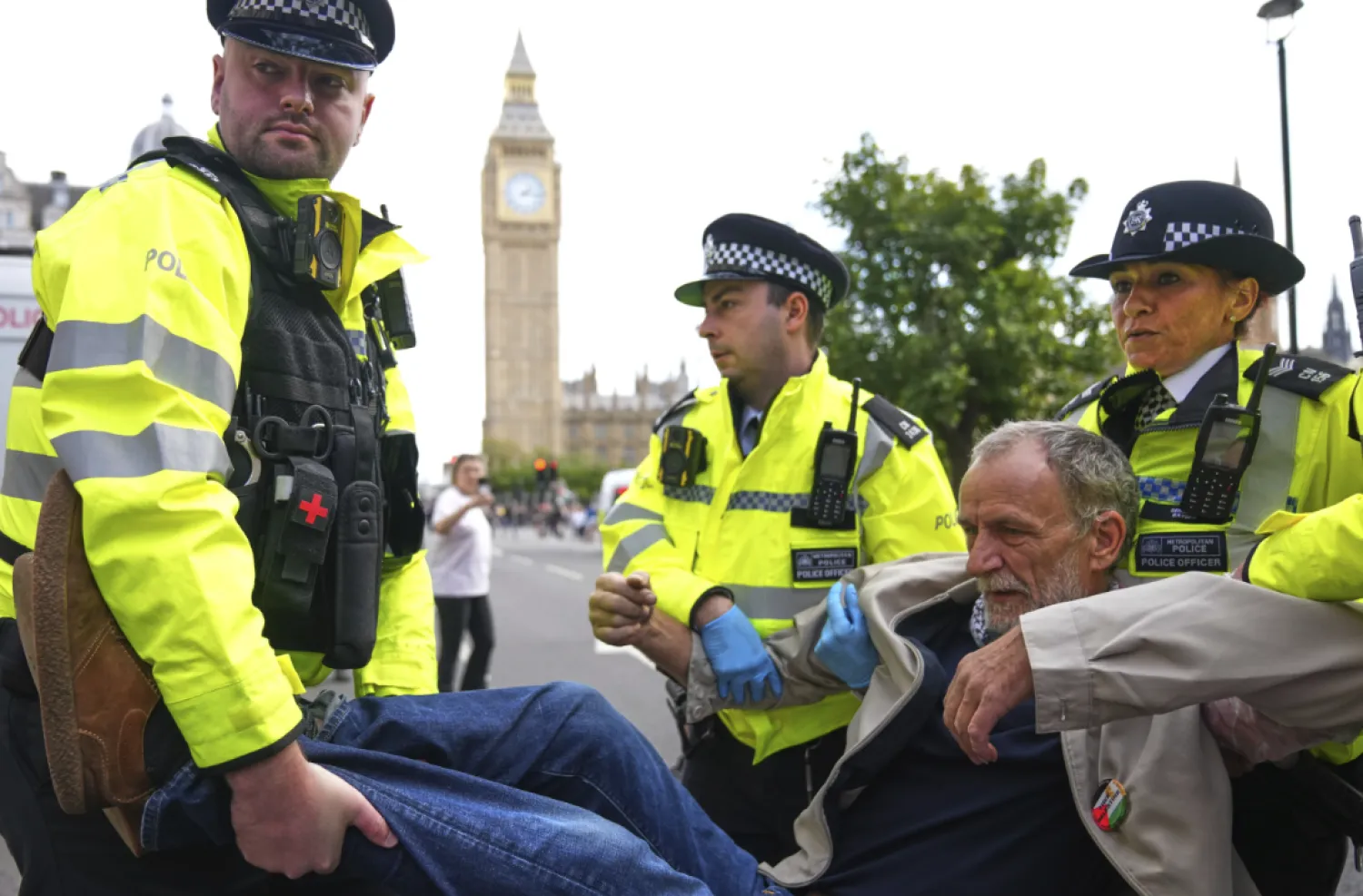 Police officers carry a protester during a protest to support Palestine Action in London, Saturday, Sept. 6, 2025.(AP Photo/Joanna Chan)