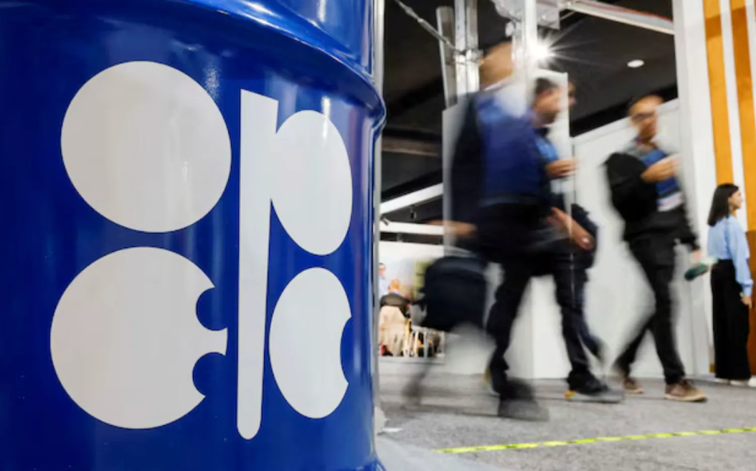 People walk past an installation depicting barrel of oil with the logo of Organization of the Petroleum Exporting Countries (OPEC) during the COP29 United Nations climate change conference in Baku, Azerbaijan November 19, 2024. REUTERS/Maxim Shemetov/File Photo 