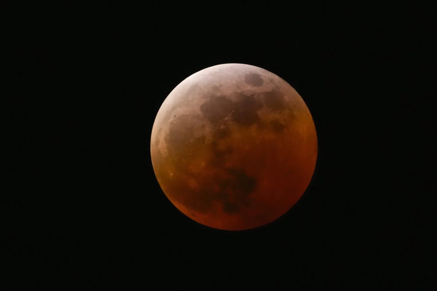 FILE - The moon shines over Mexico City during a total lunar eclipse, in Mexico City, Friday, March 14, 2025. (AP Photo/Marco Ugarte, File)