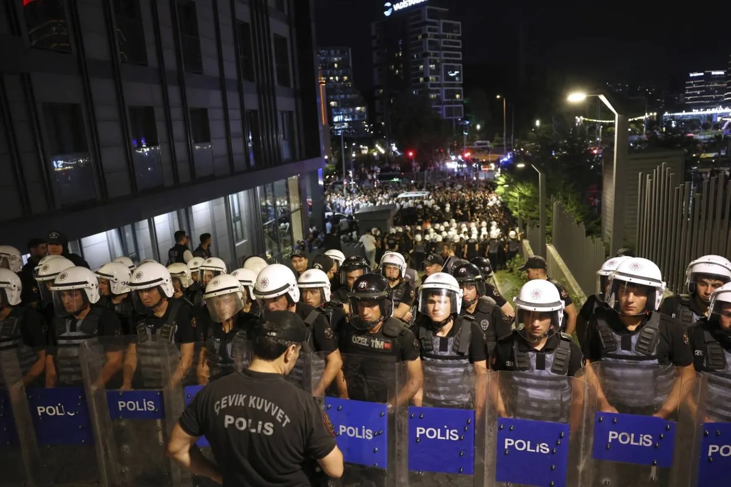 Turkish police officers stand guard as they block access to Türkiye's main opposition CHP party headquarters in Istanbul, Türkiye, Sunday, Sept. 7, 2025. (AP Photo/Berk Ozkan) 