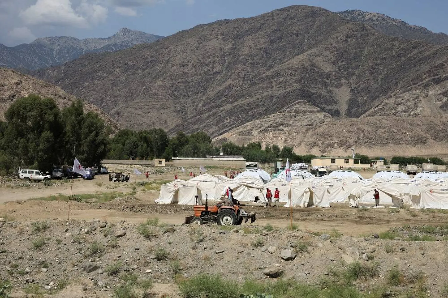 Volunteers walk amid tents set up for victims in Nurgal district, Kunar province, Afghanistan, September 6, 2025. (Reuters)