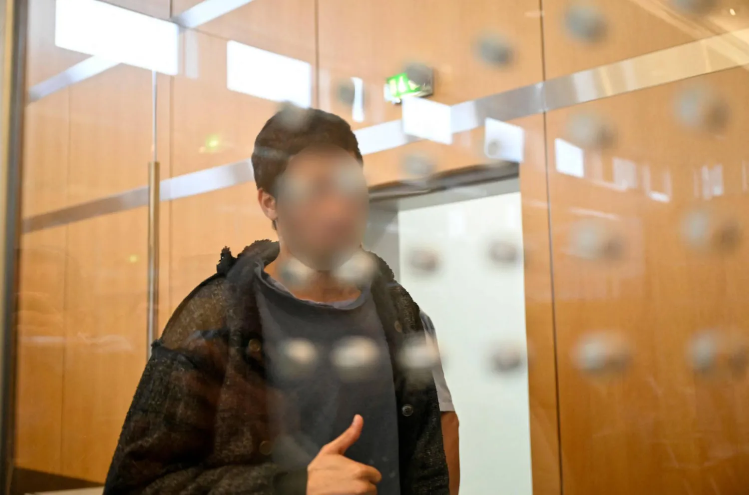 Syrian defendant Issa Al H arrives at court in Duesseldorf, western Germany, for his sentence at the end of his trial over a deadly knife attack that killed three people in August 2024 in Solingen, western Germany, during a summer city festival. (Photo by INA FASSBENDER / AFP)