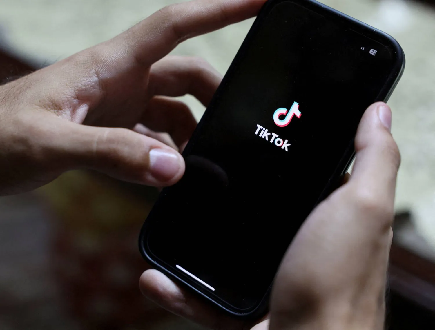 FILE PHOTO: An Egyptian man opens the TikTok app at his residence in Cairo, Egypt, August 20, 2025. REUTERS/Amr Abdallah Dalsh/File Photo