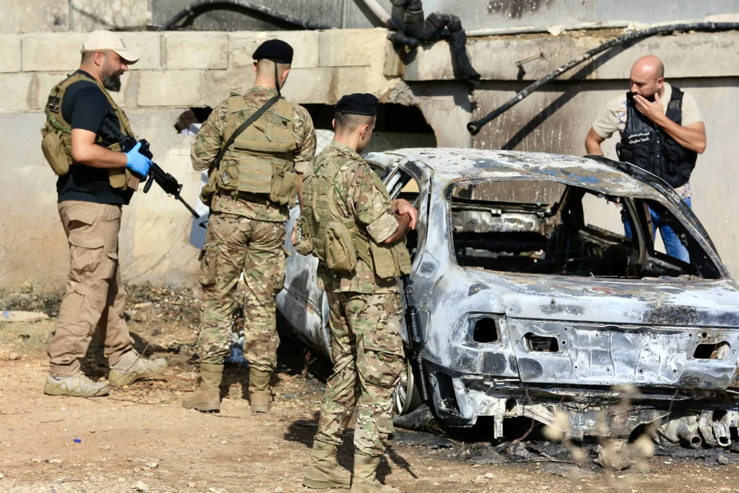 Lebanese army soldiers stand next to a vehicle that was targeted by an Israeli drone near the mosque of Zarout, between the towns of Jiyeh and Barja, south of Beirut, Lebanon, 09 September 2025. EPA