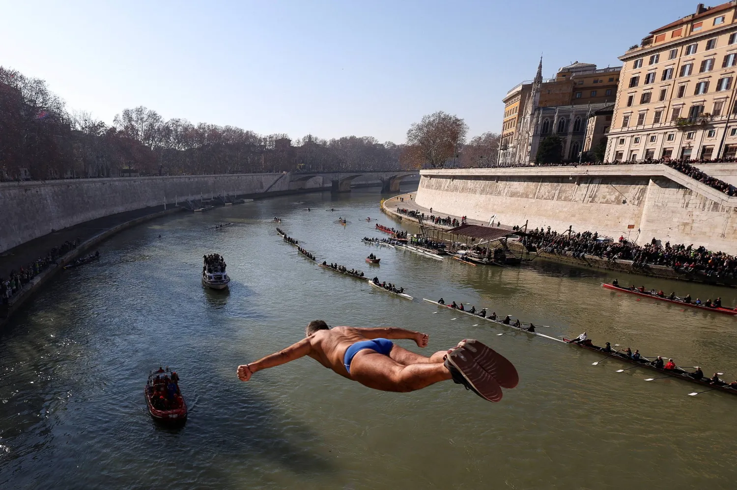 FILE PHOTO: Walter Schirra dives into the Tiber River from the Cavour bridge, as part of traditional New Year celebrations, in Rome, Italy, January 1, 2025. REUTERS/Claudia Greco/File Photo