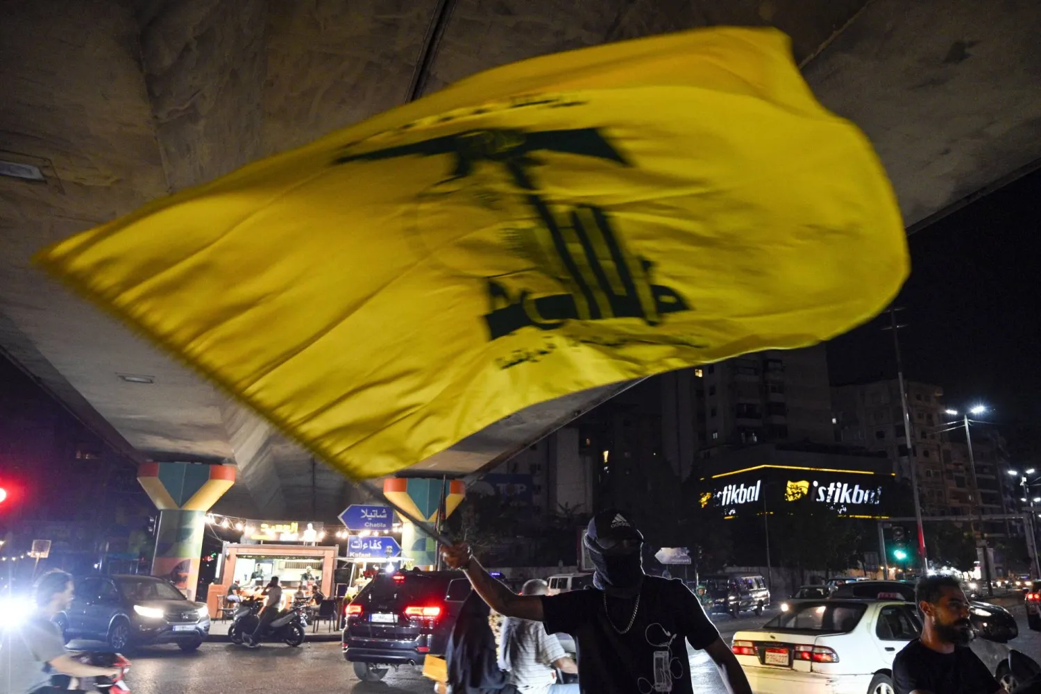 A supporter waves a Hezbollah flag in a southern suburb of Beirut, Lebanon, 05 September 2025. EPA/WAEL HAMZEH