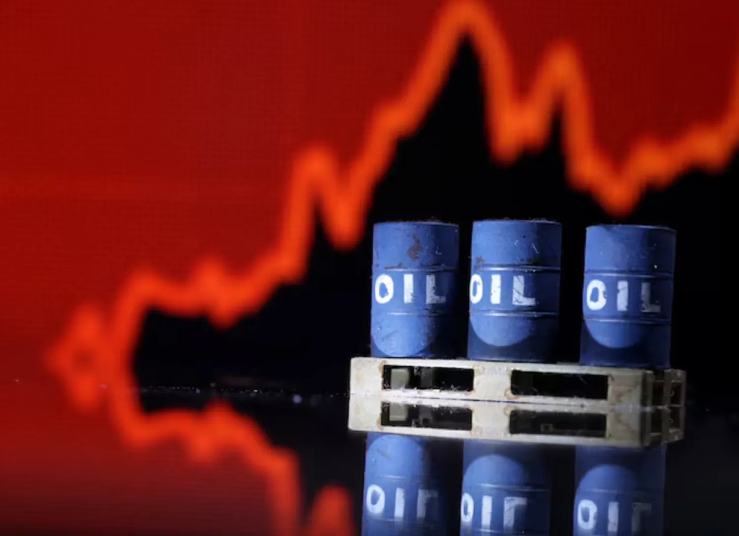 Model of Oil barrels are seen in front of rising stock graph in this illustration, July 24, 2022. REUTERS/Dado Ruvic/Illustration
