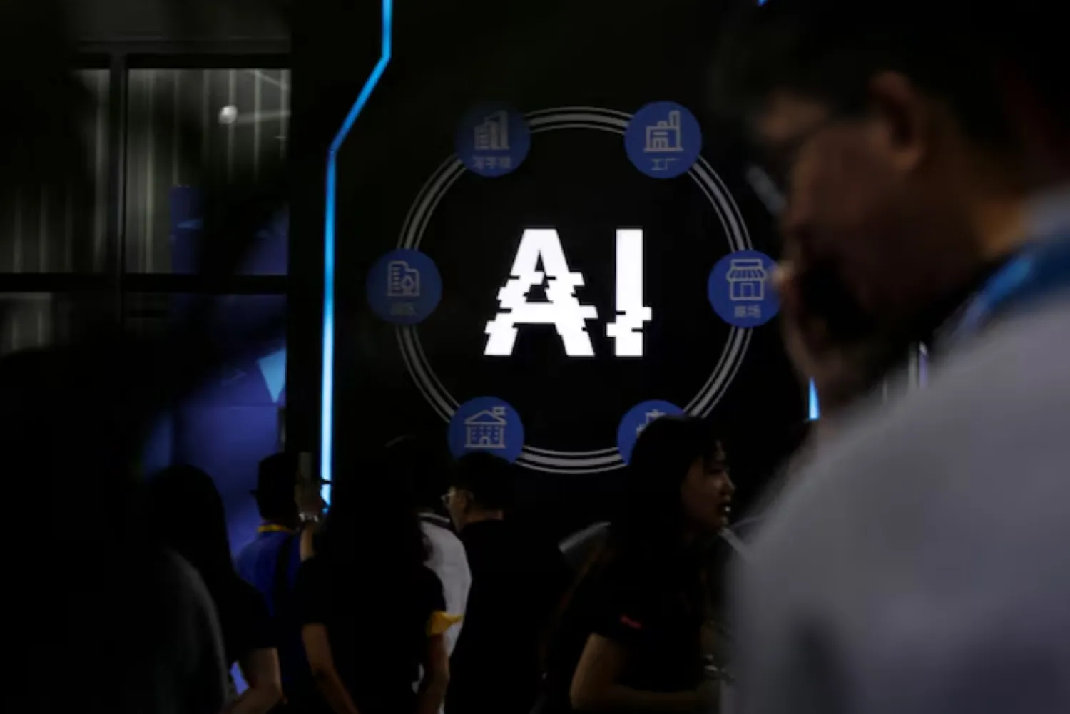 FILE PHOTO: Visitors stand near a sign of artificial intelligence at an AI robot booth at Security China, an exhibition on public safety and security, in Beijing, China June 7, 2023. REUTERS/Florence Lo/File Photo - RC24E1AXHNMZ 