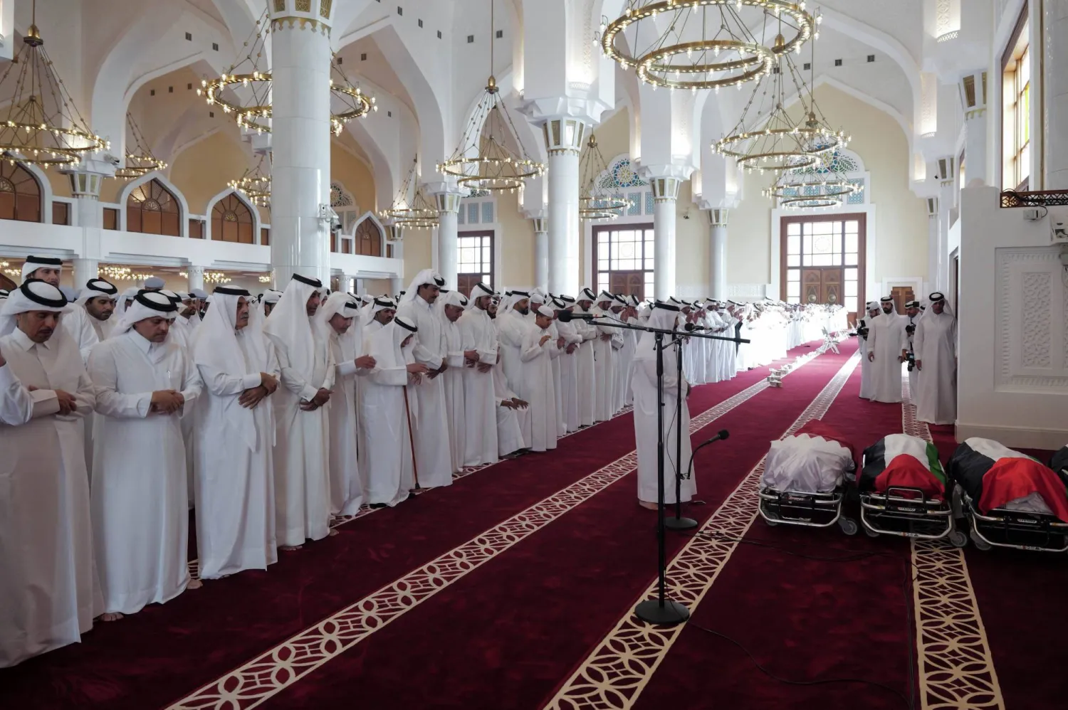 This handout picture made available by the Qatar Amiri Diwan, shows Qatar's Emir Sheikh Tamim bin Hamad Al-Thani (C) attending the funeral of people killed in an Israeli strike on figures of the Palestinain Hamas movement two days earlier, at Sheikh Mohammed bin Abdul Wahhab Mosque in Doha on September 11, 2025. (Photo by Qatar Amiri Diwan / AFP)