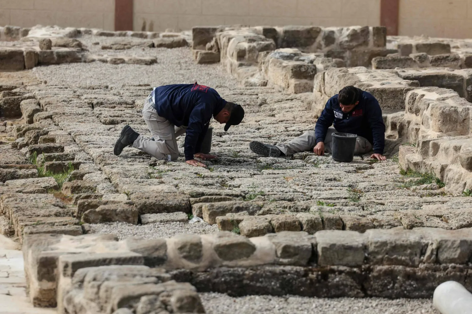 (FILES) Palestinian students work at the archaeological site of Saint Hilarion, also known as Tell Umm Amer, in the central Gaza Strip on March 7, 2023. (Photo by Mahmud HAMS / AFP)