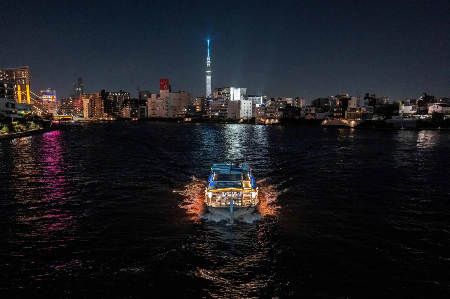 This picture taken on September 7, 2025 shows a yakatabune sightseeing boat sailing along the Sumida river in Tokyo. (Photo by Philip FONG / AFP)