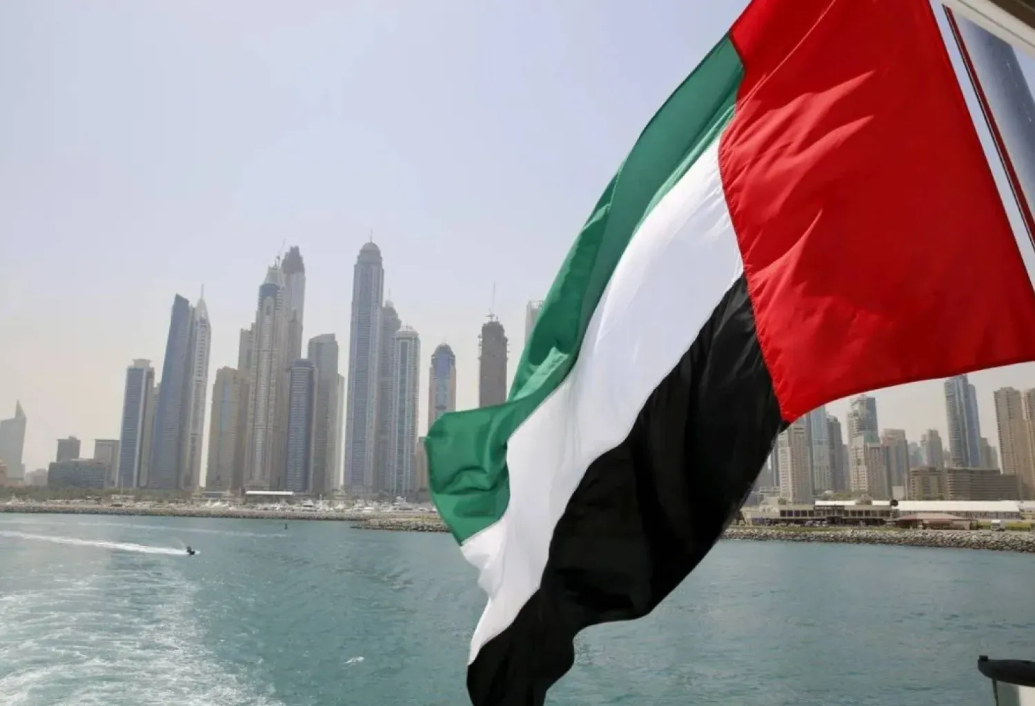 UAE flag flies over a boat at Dubai Marina, Dubai, United Arab Emirates May 22, 2015. REUTERS/Ahmed Jadallah/File Photo
