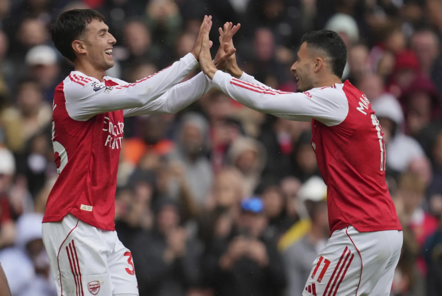 Arsenal's Martín Zubimendi, left, and Gabriel Martinelli celebrate after a goal during the Premier League soccer match between Arsenal and Nottingham Forest in London, Saturday, Sept. 13, 2025. (AP Photo/Kin Cheung)