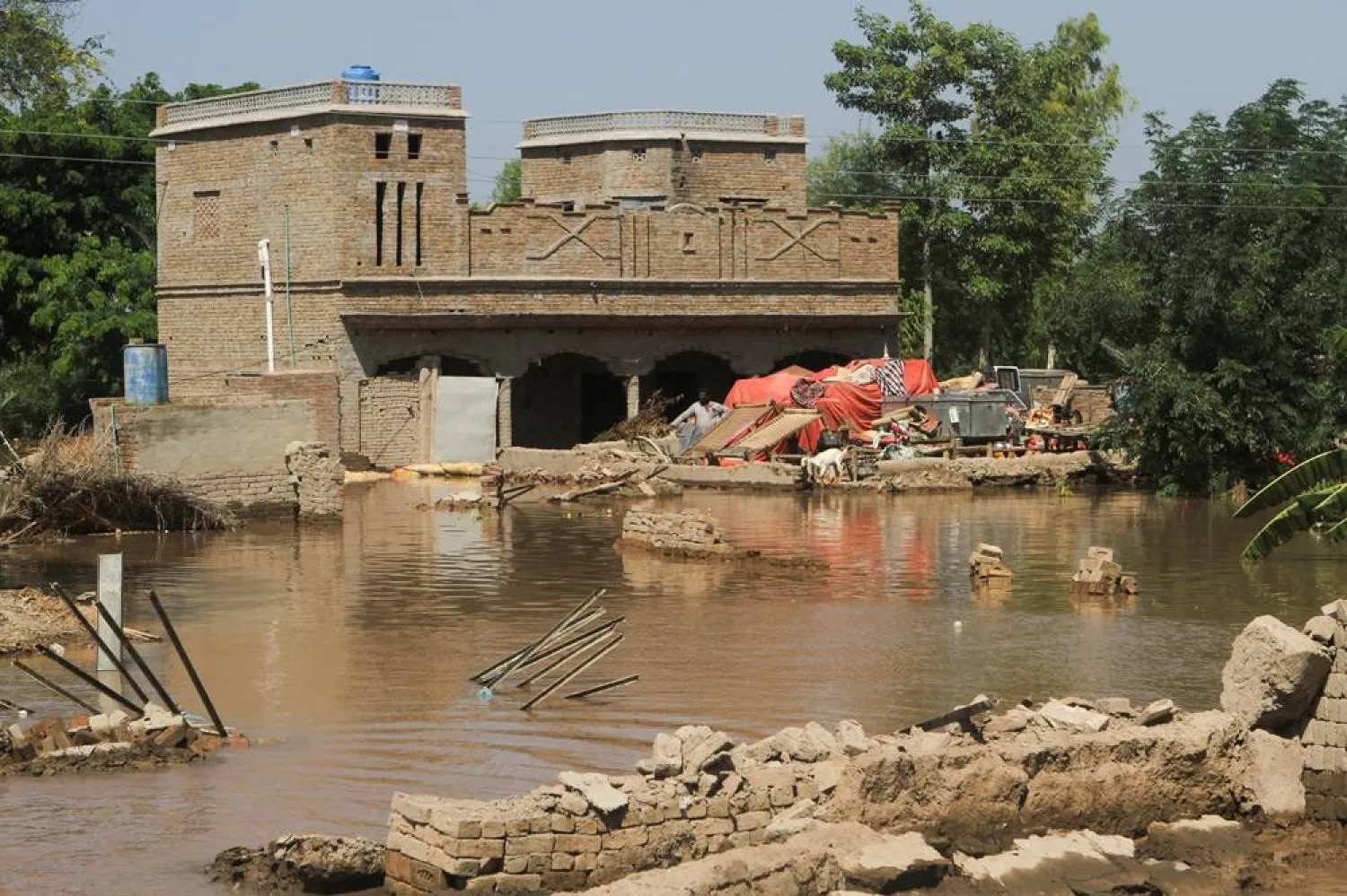 Resident Waseem Ahmed stands by his partially damaged home, following monsoon rains and rising water levels of the Chenab River, in Seetpur, Punjab province, Pakistan, September 13, 2025. (Reuters)