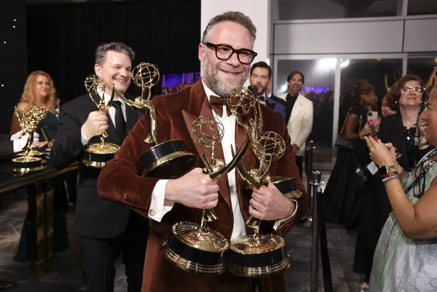 Seth Rogen picks up their official Emmy statuette at the 77th Emmy Awards Trophy Table on Sunday, Sept. 14, 2025 at the Peacock Theater in Los Angeles. (Mark Von Holden/Invision for the Television Academy/AP Content Services)