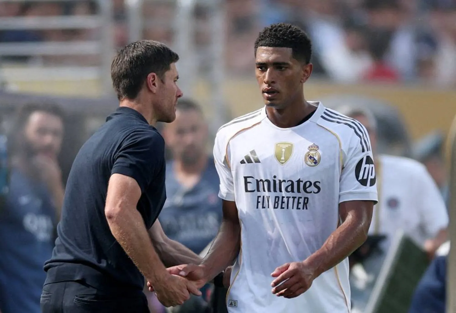Football - FIFA Club World Cup - Semi Final - Paris St Germain v Real Madrid - MetLife Stadium, East Rutherford, New Jersey, US - July 9, 2025 Real Madrid's Jude Bellingham shakes hands with coach Xabi Alonso after being substituted. (Reuters) 