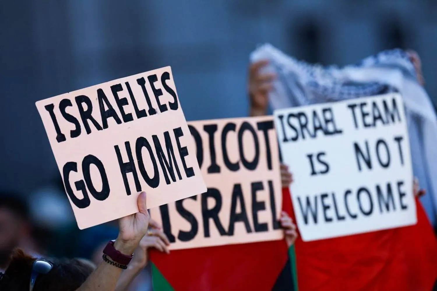Pro-Palestinian protestors hold up banners before invading the street and forcing race organizers to abandon the 21st and last stage of the Vuelta a Espana 2025, a 101 km race between Alalpardo and Madrid, in Madrid on September 14, 2025. (AFP) 