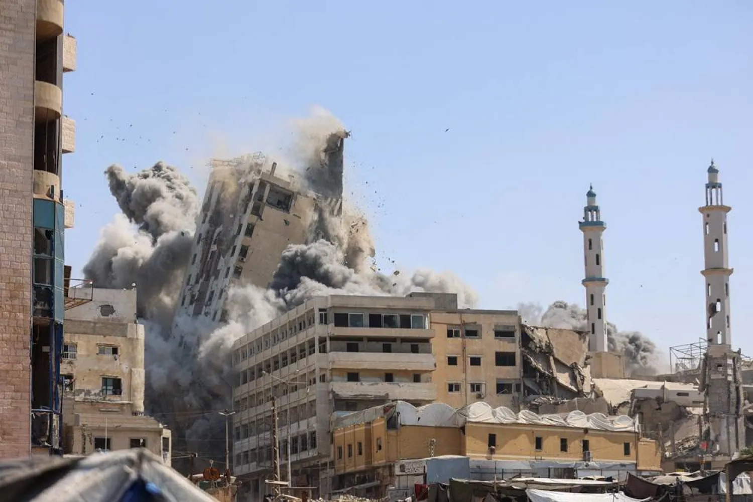 Smoke billows as Israeli airstrikes destroy the al-Ghafari tower in Gaza City on September 15, 2025. (AFP)