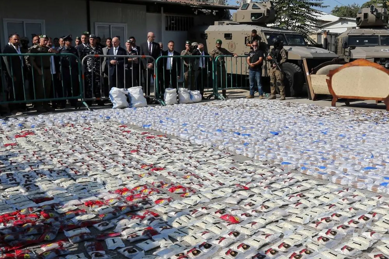 Director General of Internal Security Forces Major General Raed Abdallah (4-L), Lebanese Interior and Municipalities Minister Ahmad al-Hajjar (5-L), and members of the Information Branch stand next to bags containing pills of drugs, a substance of Captagon displayed on the floor at the headquarters of the Information Branch in Beirut, Lebanon, 15 September 2025. (EPA)