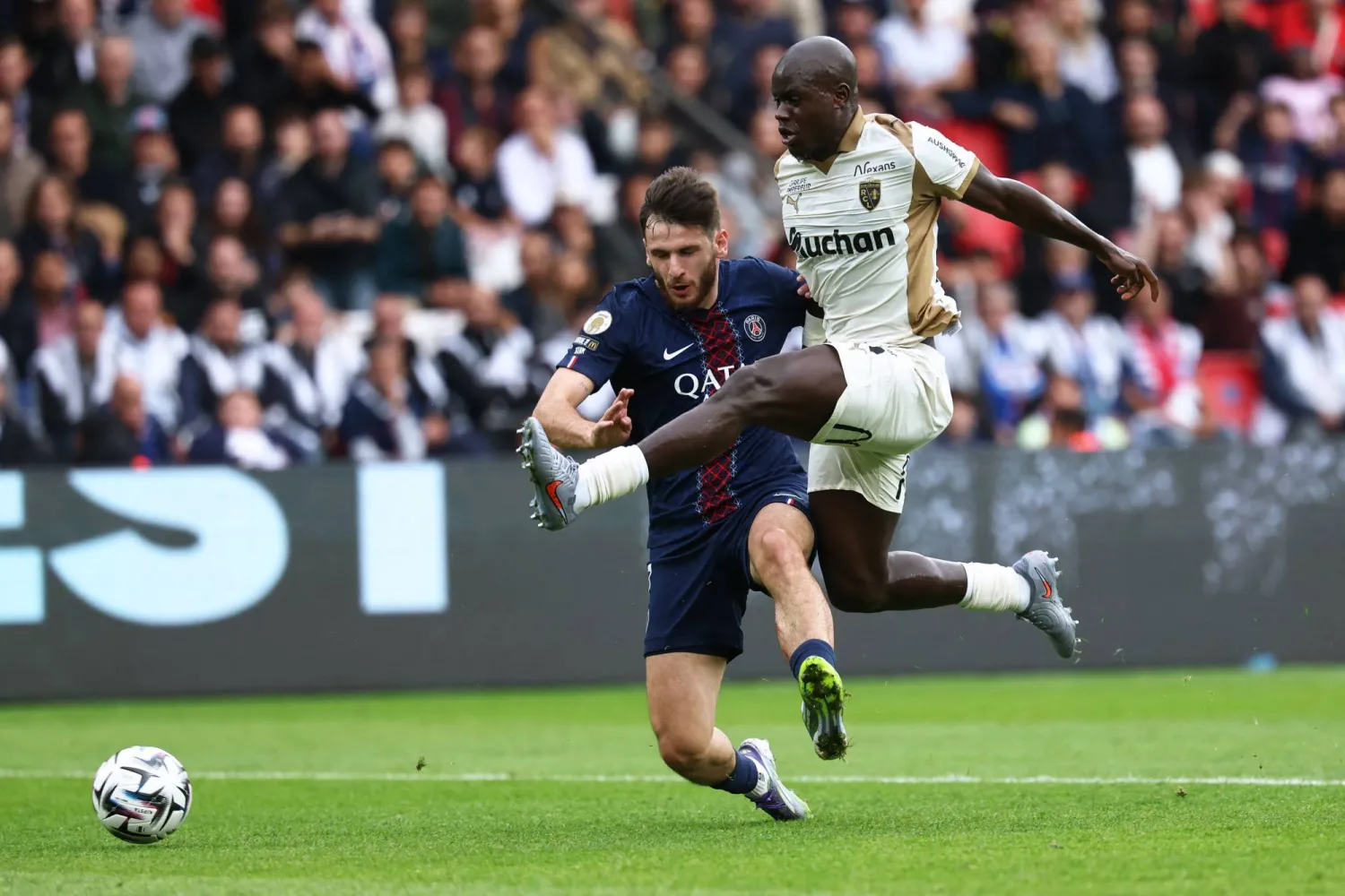 Paris Saint-Germain's Georgian forward #07 Khvicha Kvaratskhelia (L) fights for the ball with Lens' French defender #20 Malang Sarr during the French L1 football match between Paris Saint-Germain (PSG) and RC Lens at the Parc des Princes stadium in Paris, on September 14, 2025. (AFP)