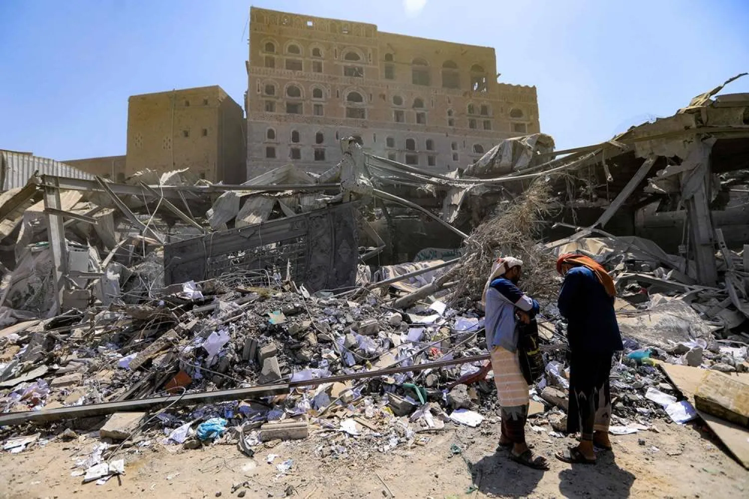 People check the rubble of a building, days after it was levelled by an Israeli strike in the Houthi-run Yemeni capital Sanaa, on September 14, 2025. (AFP)