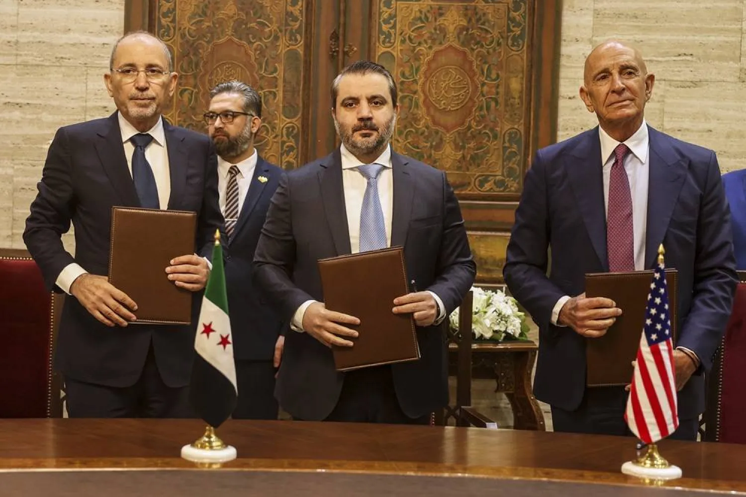 US Ambassador to Türkiye and Special Envoy to Syria Tom Barrack, right, Jordanian Foreign Minister Ayman Safadi, left, and Syrian Foreign Minister Asaad al-Shaibani pose for a photograph after signing a roadmap to restore security in southern Syria, in Damascus, Syria, Tuesday, Sept. 16, 2025. (AP) 